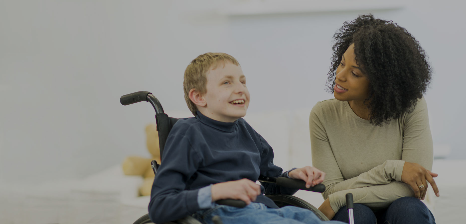 Aide talking to child with disability