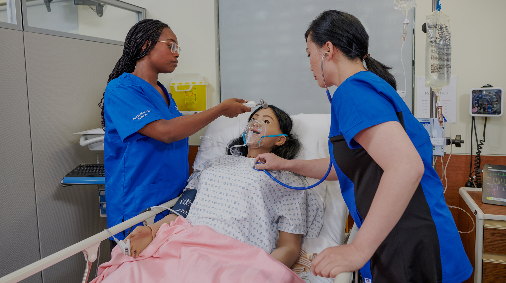 Nursing students practice on a dummy patient